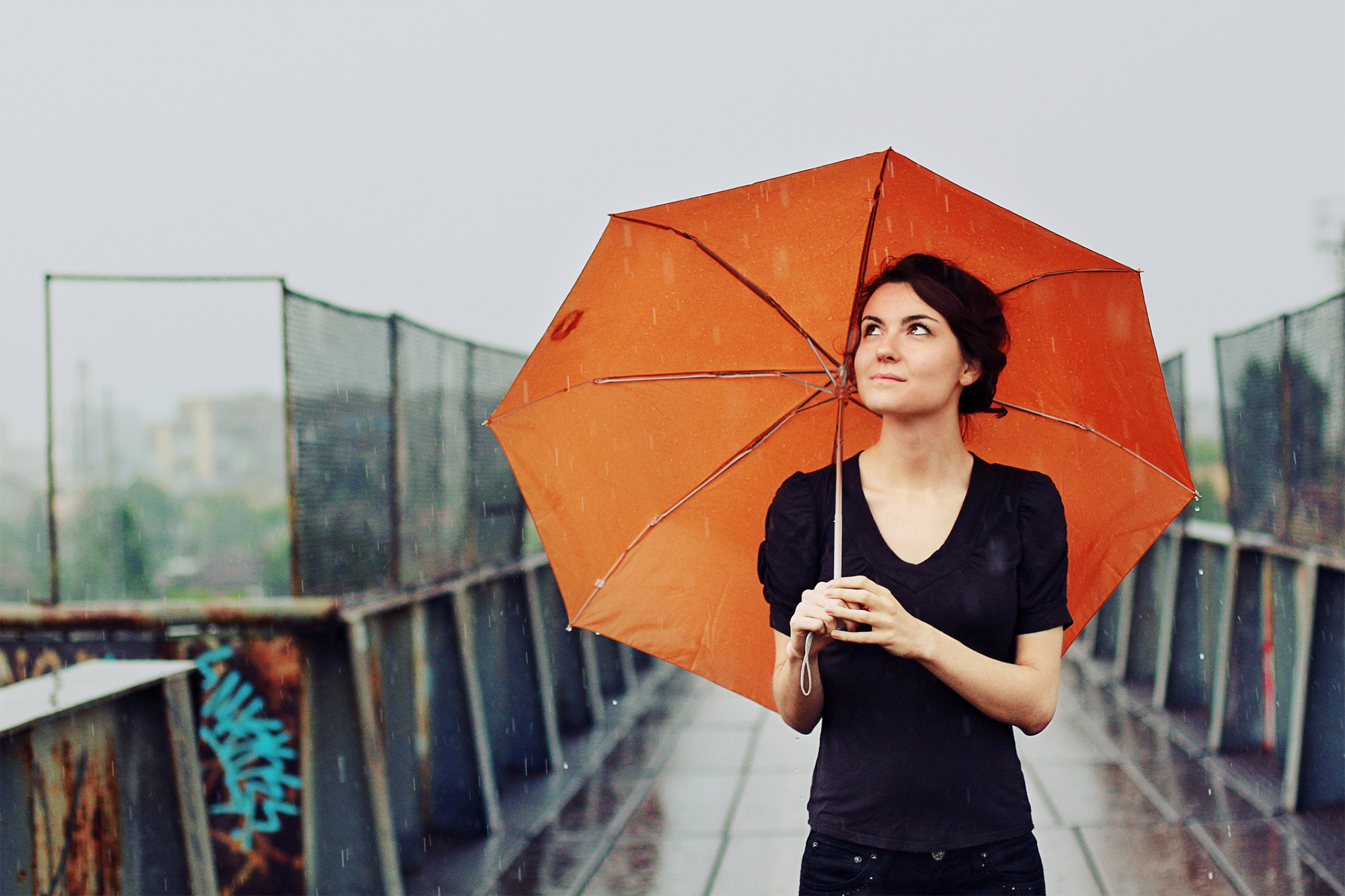 A lady holding an umbrella in the rain
