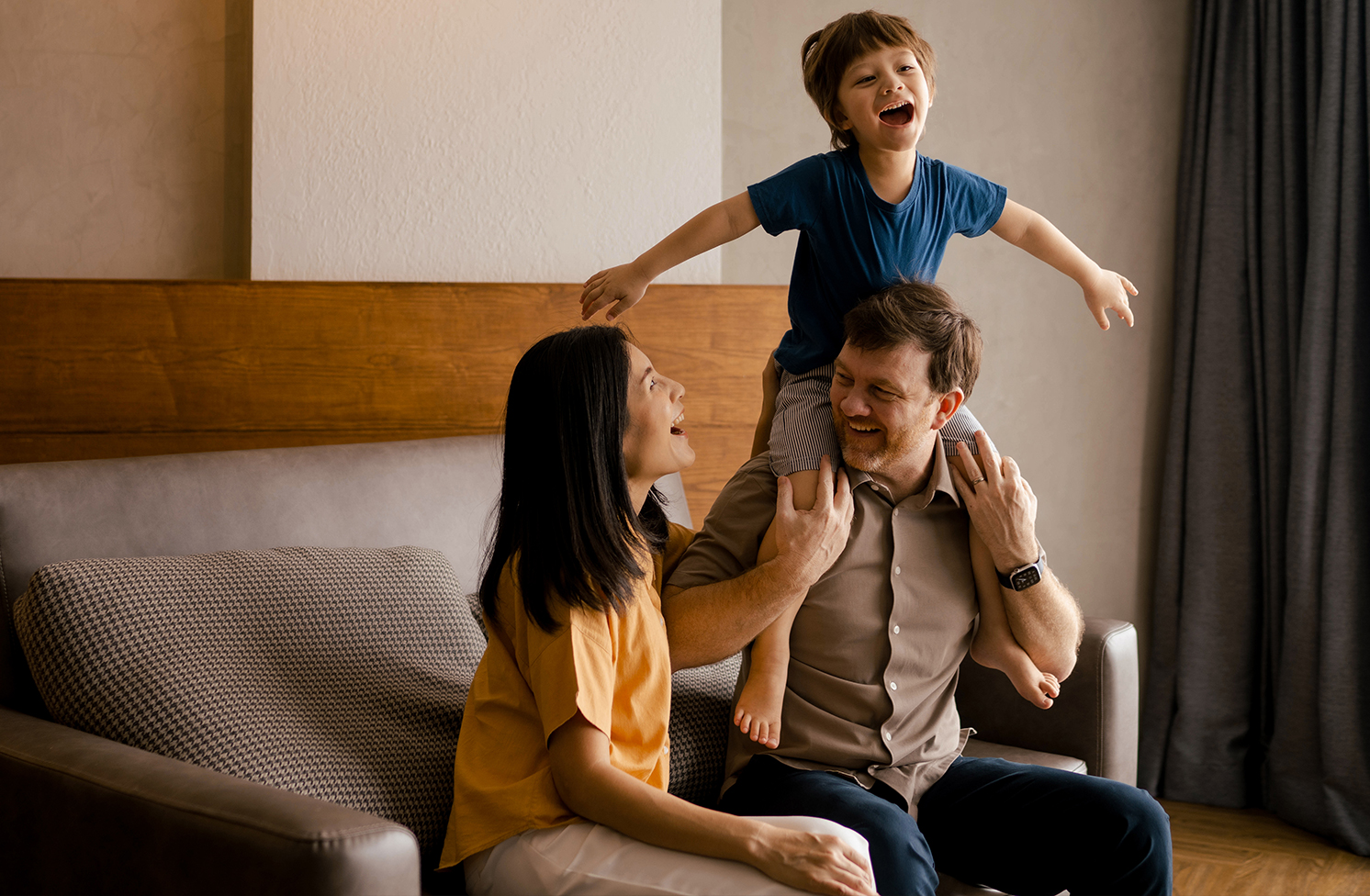A Father and Mother laughing with their Son