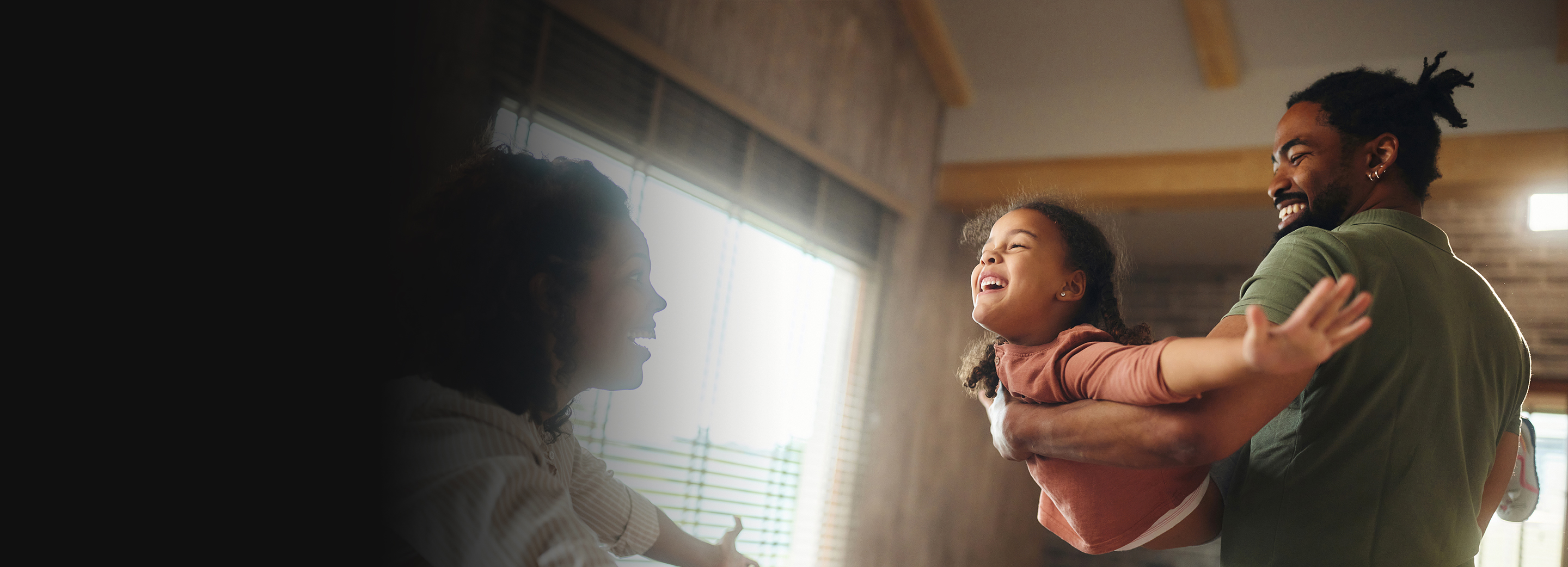 A Mother and Father playing with their Daughter