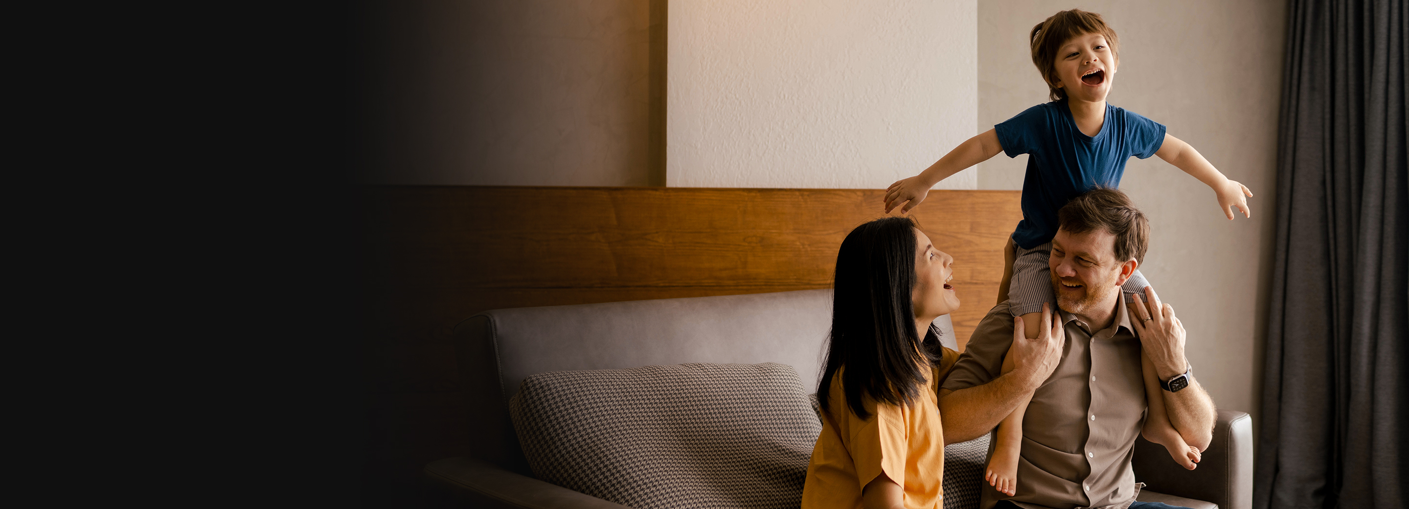 A Father and Mother laughing with their Son