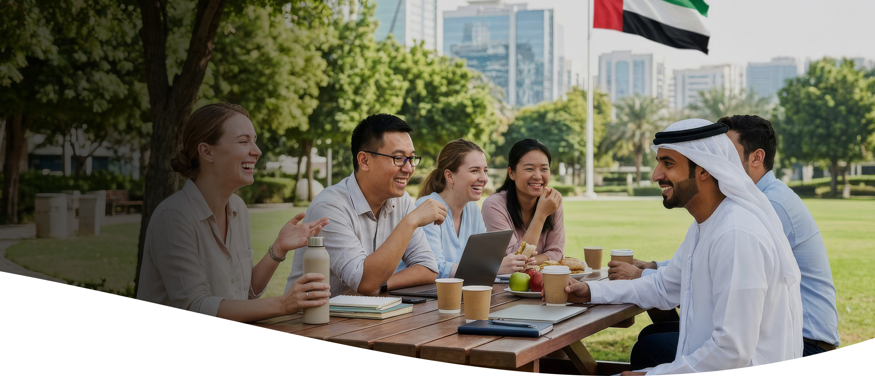 Colleagues having a meeting outdoors in a park in the UAE