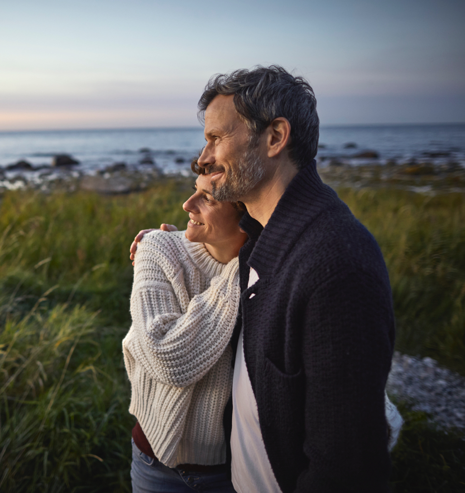 A couple hugging and looking into the distance