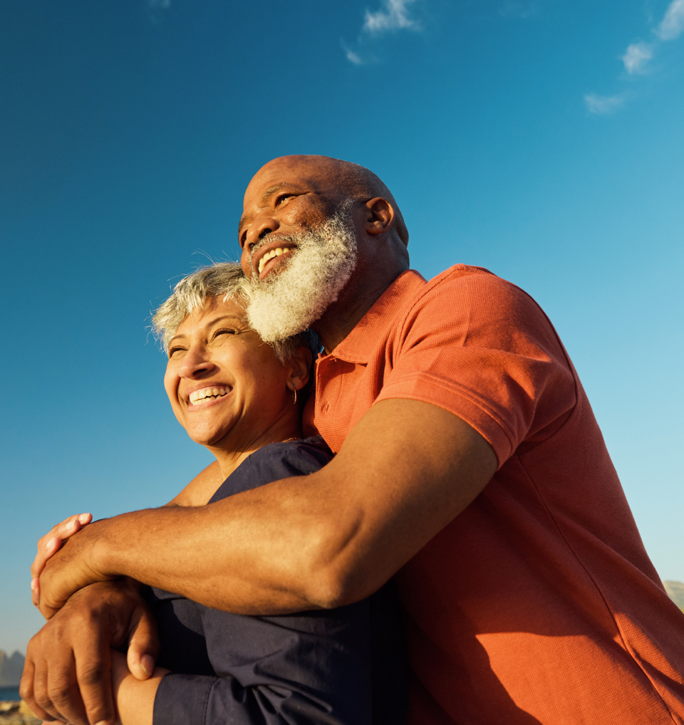 A couple hugging and looking into the distance
