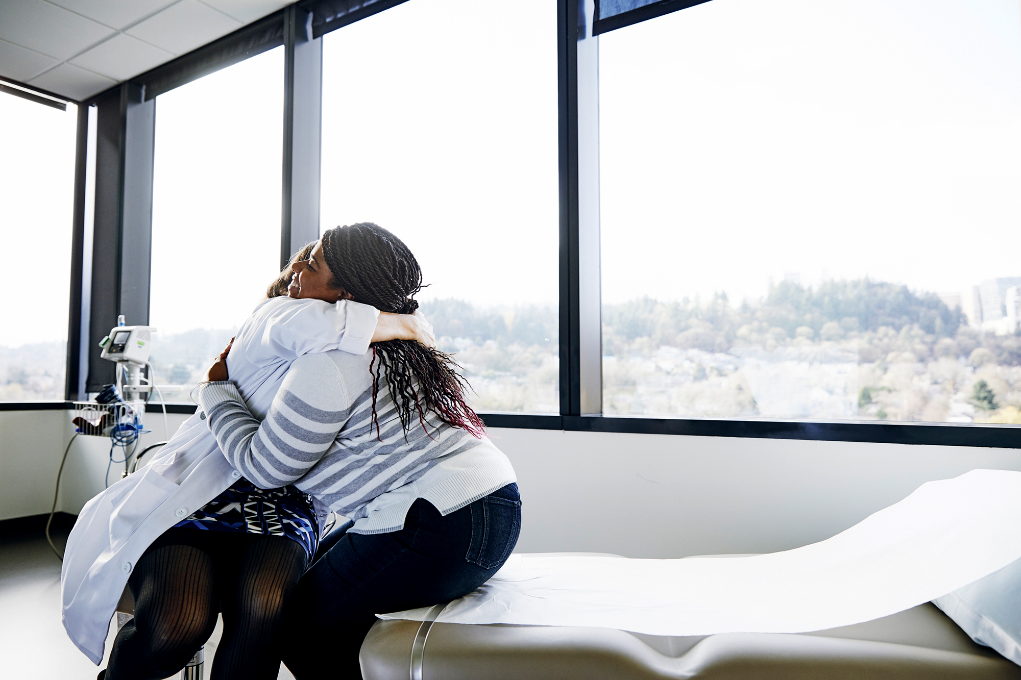 A lady using a hugging a doctor