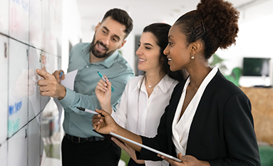 Group of people eating food around a table