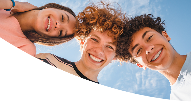 Group of smiling friends looking down at the camera